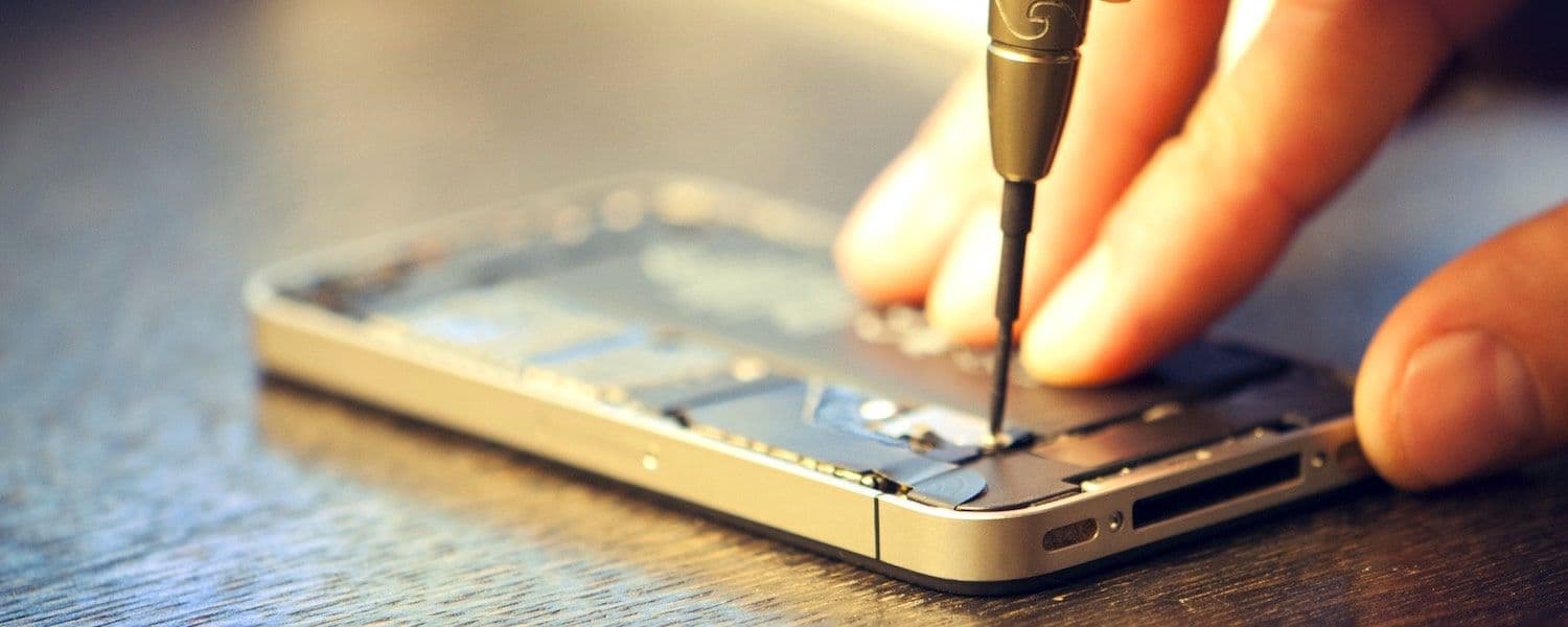 Techniker öffnet ein iPhone mit einem Präzisionsschraubendreher